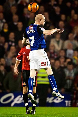 Rochdale v FC United of Manchester - Jason Kennedy wins the aerial battle with Nicky Platt