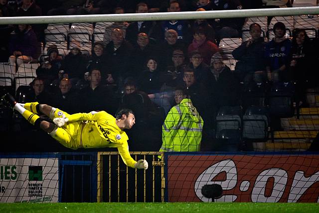 Rochdale v FC United of Manchester - Josh Lillis dives in a fruitless effort to save Jake Cotterell superbly struck shot