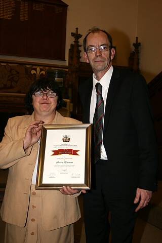 Councillor Emmott receives her award from Council Leader Colin Lambert