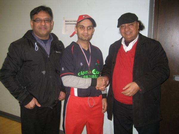 Qunain Shah receives his man of the match award from M Amin, league umpire.