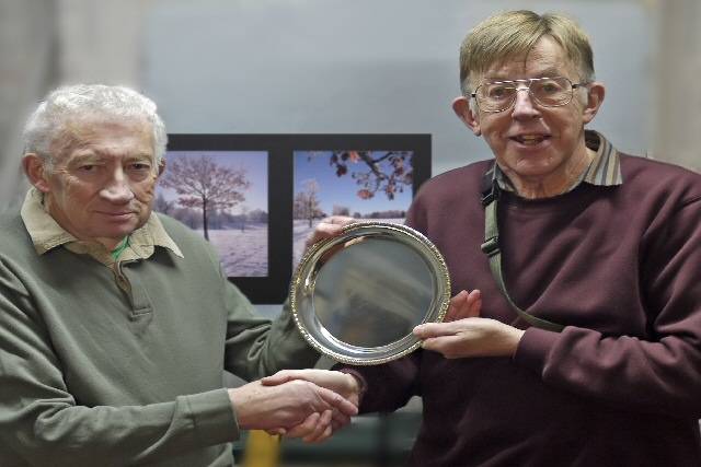 Harry Muncaster, President of Rochdale Photographic Society (left), awards Mike Davis the President's Competition Plate for his winning photos