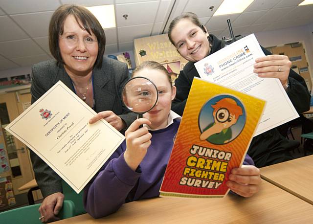 Crime reduction advisor Jackie Bell and PCSO Rachel Williams with a pupil from Sandbrook Park Primary School.