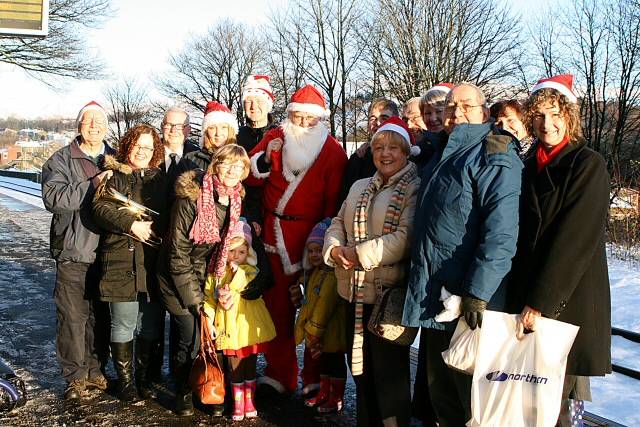 Members of STORM, the Friends of Littleborough Stations, the Littleborough Public Brass Band, train passengers and Santa at Littleborough Station