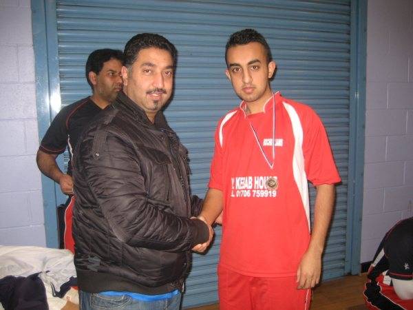 Faisal of Rocdalians receiving Man of the match award from Atique Malik owner of Home-2-Home furnishing