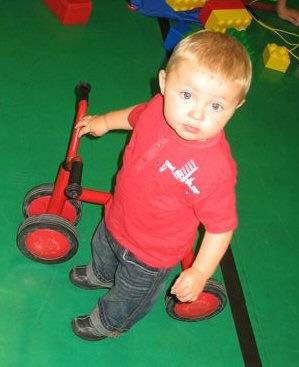 Toddler Leighton Wilson enjoying the trikes