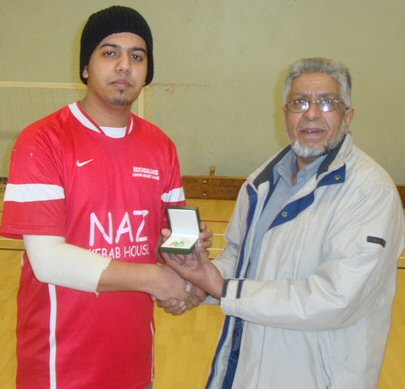 Councillor Sharif presents the man of the match award to Abdullah of Idara Allstars.