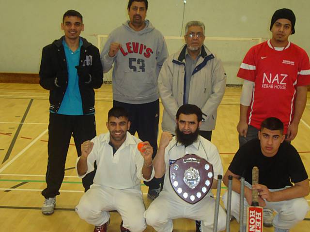 Idara Allstars celebrate their tournament win with Councillor Sharif.