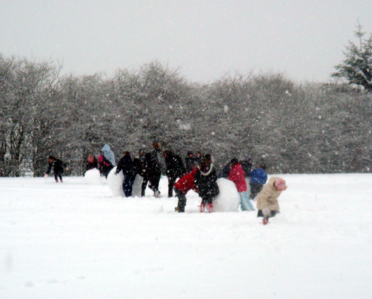 Children play in the snow at Healey Primary School