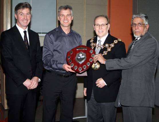 Chief Superintendent John O’Hare and Rochdale Police football team captain Daryl Butterworth collect their award from Mayor Swift and Councillor Sharrif