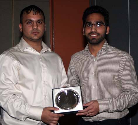 Ibrar Khan (left) collects his services to young people award