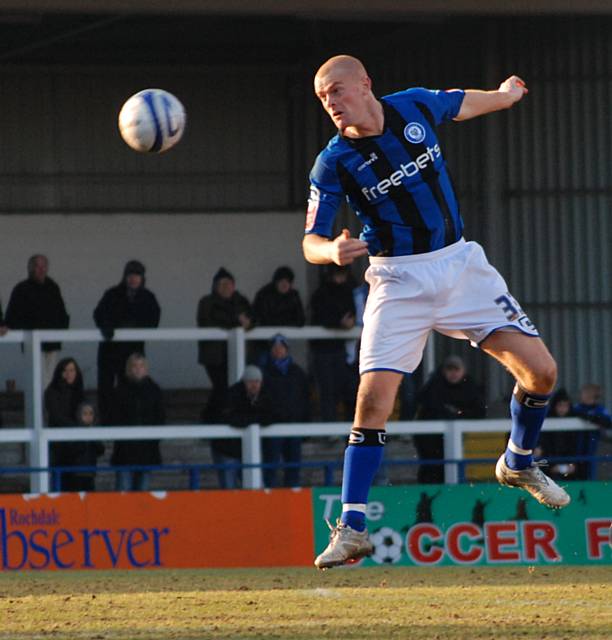 Jason Taylor heads the ball down.