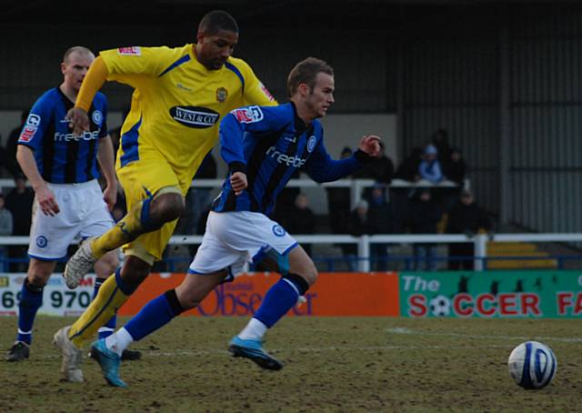 Kallum Higginbotham bursts past Josh Scott.