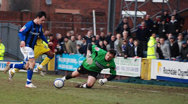 Dagnall takes the ball round Roberts.