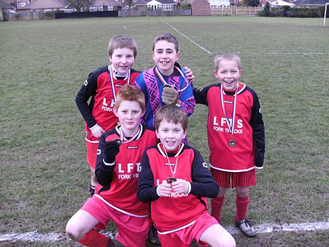 The under 11 Football Team with their bronze medals