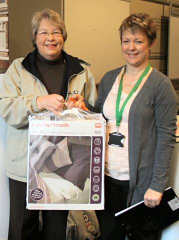 Janet Whittles from Bamford gets her free replacement blanket from Joanne Redford at the safety event