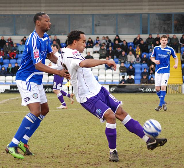 Chris O'Grady holds the ball up, away from Nat Brown.