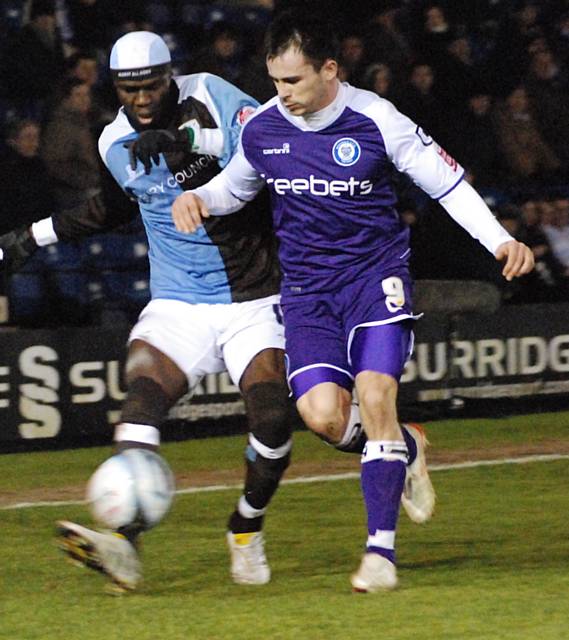 Efe Sodje and Dagnall battle for possession.