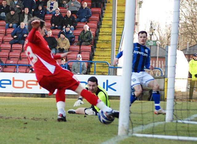 Dagnall sees his shot cleared off the line by Matt Tootle.