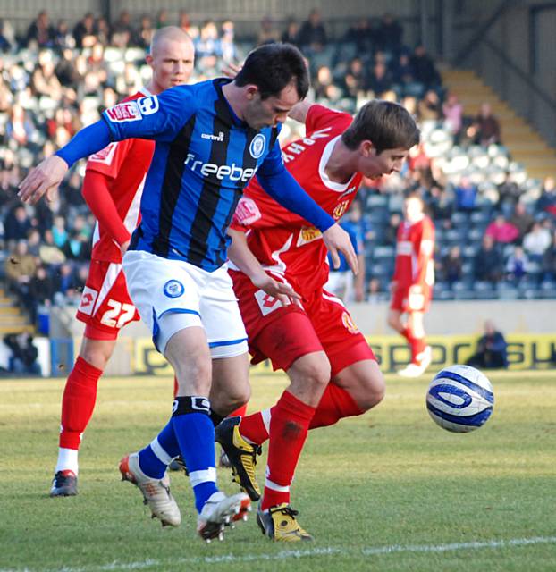 Dagnall puts pressure on Ashley Westwood.