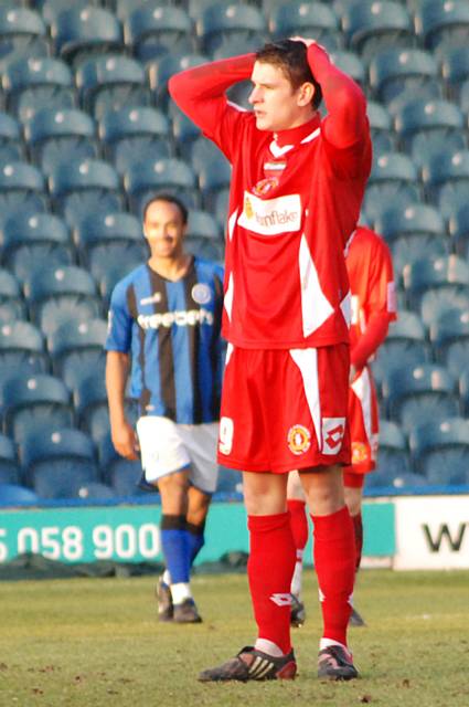 Tootle stands hands on head after his own goal ensures victory for Rochdale.