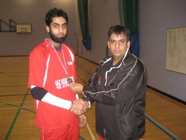 Asif of Rochdalians receiving man of the match award from M Siddique (organiser of the league)