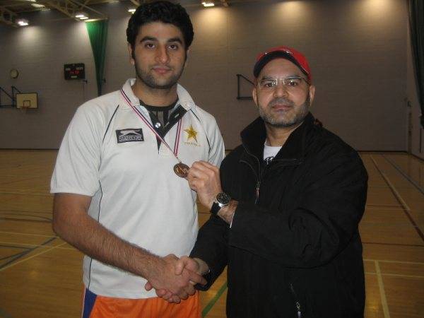 Iftikhar of Baba XI receiving man of the match award from A Quyyom (organiser of the league)