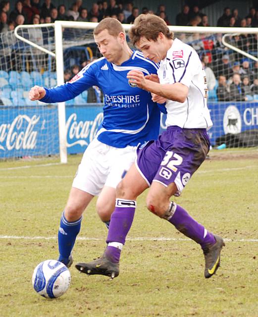 Will Atkinson battles for possession.