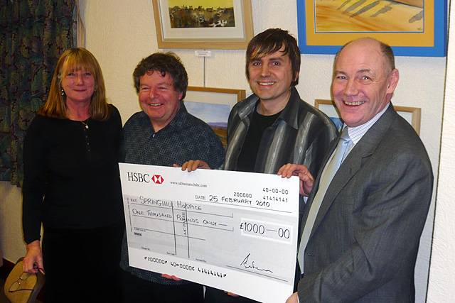 Ian Jenkins of Springhill Hospice receives a cheque from Alan Mellalieu, Richard Cafiero and Sue Sutcliffe