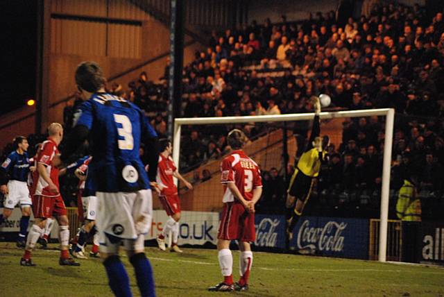 Andy Warrington turns Tom Kennedy's free kick over the crossbar.