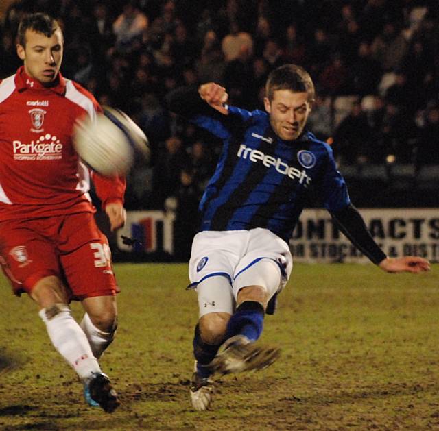 Tom Kennedy clears from former team mate Adam Le Fondre.