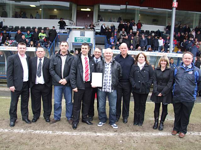 Milnrow Cobras recieveing the awards at the Hornets Vs Oldham Roughyeds game at Spotland.
Pictured (L-R): Mike Banks (Hornets CEO),  Thomas Hadley, Paul Mellors, Ryan Bradley (RFL Development Officer), Barry Woodburn (Link4Life), Tony Dawson, Mark Cumiskey, Kath Dawson, Colette Cumiskey, Mark Wynn (Hornets Chairman)
