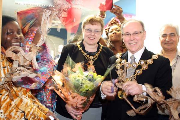 The Mayor and Mayoress of Rochdale enter the African Culture event by cutting a traditional African ribbon