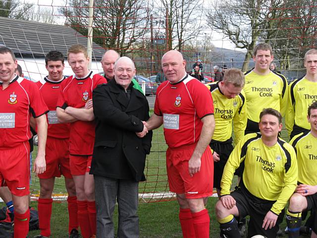 Ian Jenkins of Springhill Hospice shakes hands with Sacred Heart FCs Mick Stott