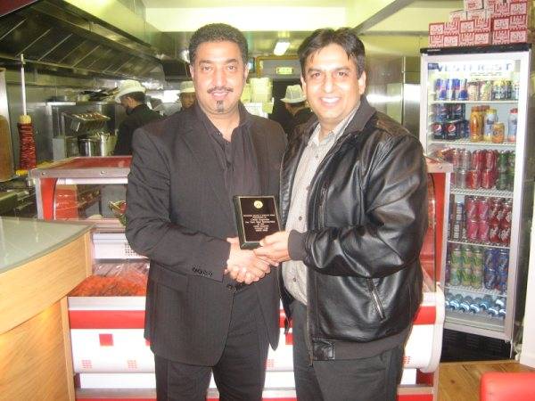 M. Saddique presenting a plaque to sponsor Toffique Malik of Chilli Express