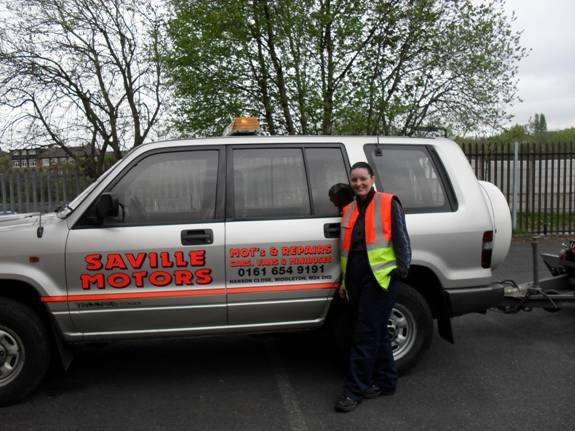 Imogene next to a Saville Motors vehicle