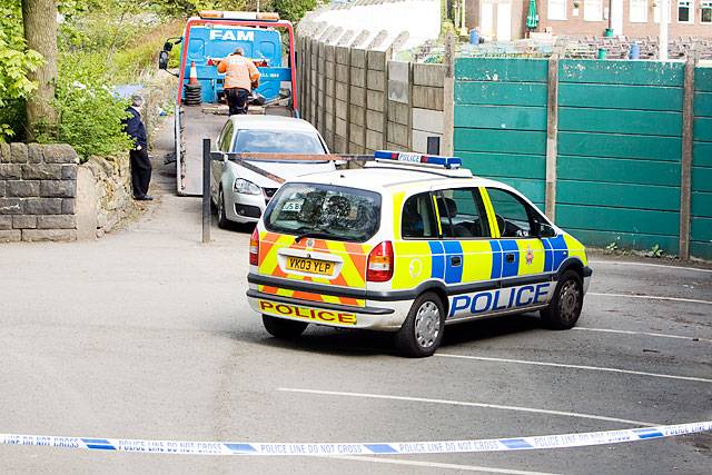 Police cordon around a VW Golf on the lane at the side of Littleborough Cricket ground at the entrance to Hare Hill Park