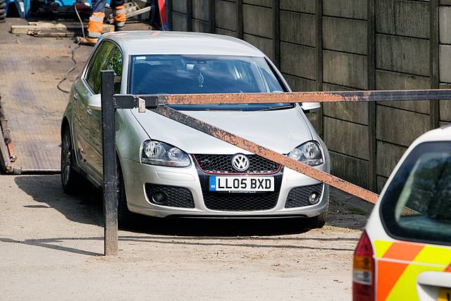 VW Golf on the lane at the side of Littleborough Cricket ground at the entrance to Hare Hill Park