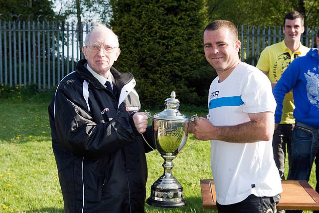 Rochdale Online Alliance Football League President John Culshaw presents the A W Trippier Cup to captain of Weavers Nick Hands