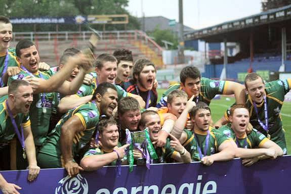 The Hopwood Hall’s Rugby League Academy team celebrating with trophy & champagne, the trophy