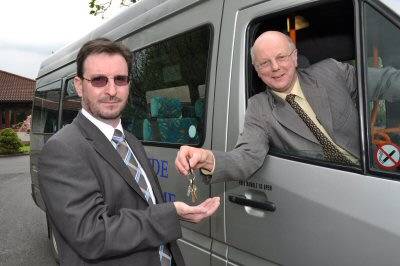 Paul Lucas, GMPTE’s Operational Service Planning Manager (right), presents the keys to the new Rochdale VDS office to Neil Foley, CEO of Heywood New Heart Community Transport