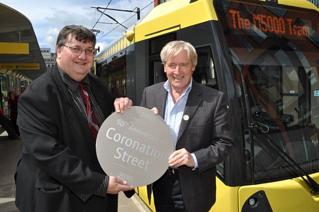 William Roache (right) who plays Ken Barlow in ITV's Coronation Street, and Cllr Keith Whitmore, Chair of GMITA (left) with a new M5000 Metrolink tram featuring a commemorative Coronation Street plaque