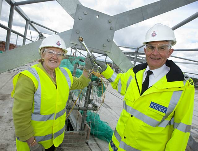 Gloria Oates, Vice Chair GMPA and GMP Chief Constable Peter Fahy screw in golden bolt 