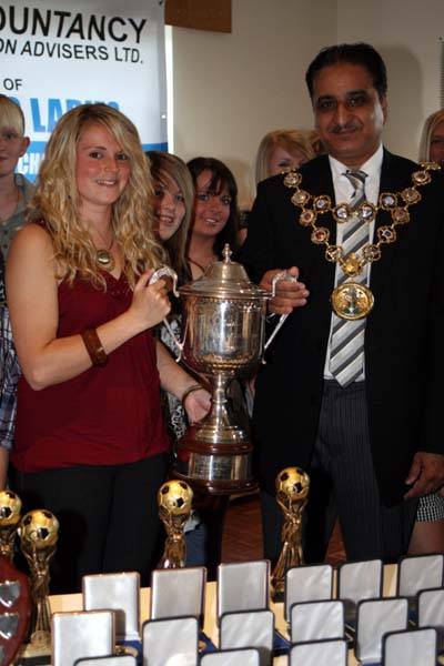 First team captain, Claire Pearson holds the Northern Combination League Cup, alongside the Mayor of Rochdale, Councillor Zulfiqar Ali