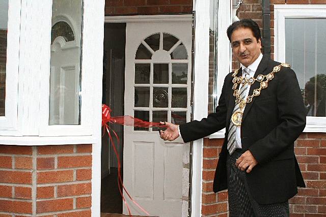 The Mayor of Rochdale, Councillor Zulfiqar Ali, cutting the ribon to Redwood House