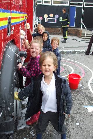 Children from St Gabriel's school cleaning the fire engine as part of a sponsored engine wash