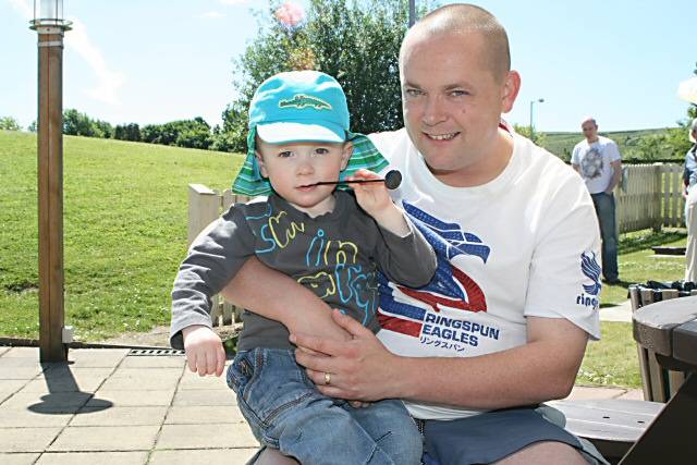 Graham Whiteside sat in the sun with his son Ky