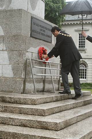 The Mayor of Rochdale, Councillor Zulfiqar Ali places a poppy wreath onto the cenotaph