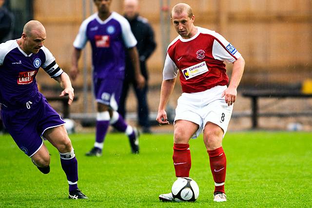 Fleetwood Town v Rochdale - Gary Jones chases Fleetwood's Ian Craney