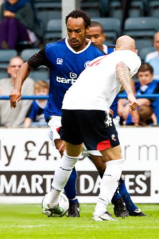 Chris O'Grady takes on the Bolton defence