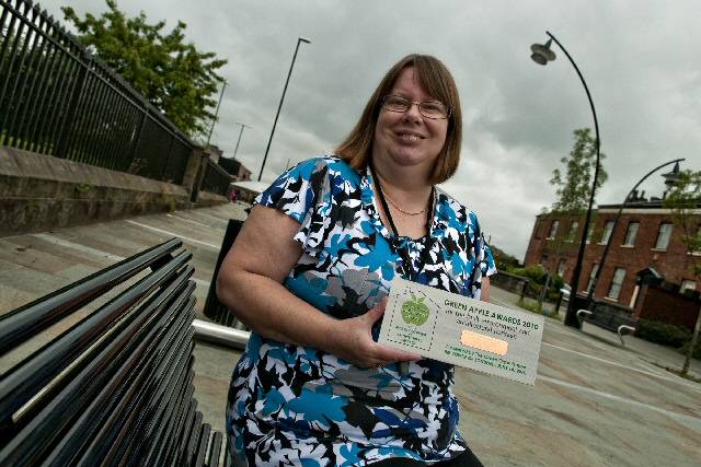 Janet Brooks, Senior Project Officer for RDA shows off the Green Apple Environment Award at the Townhead development